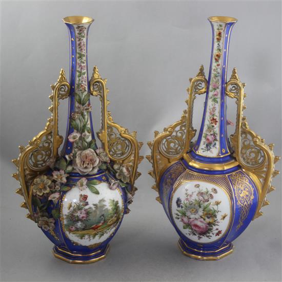 A pair of French jewelled and flower encrusted porcelain bottle vases